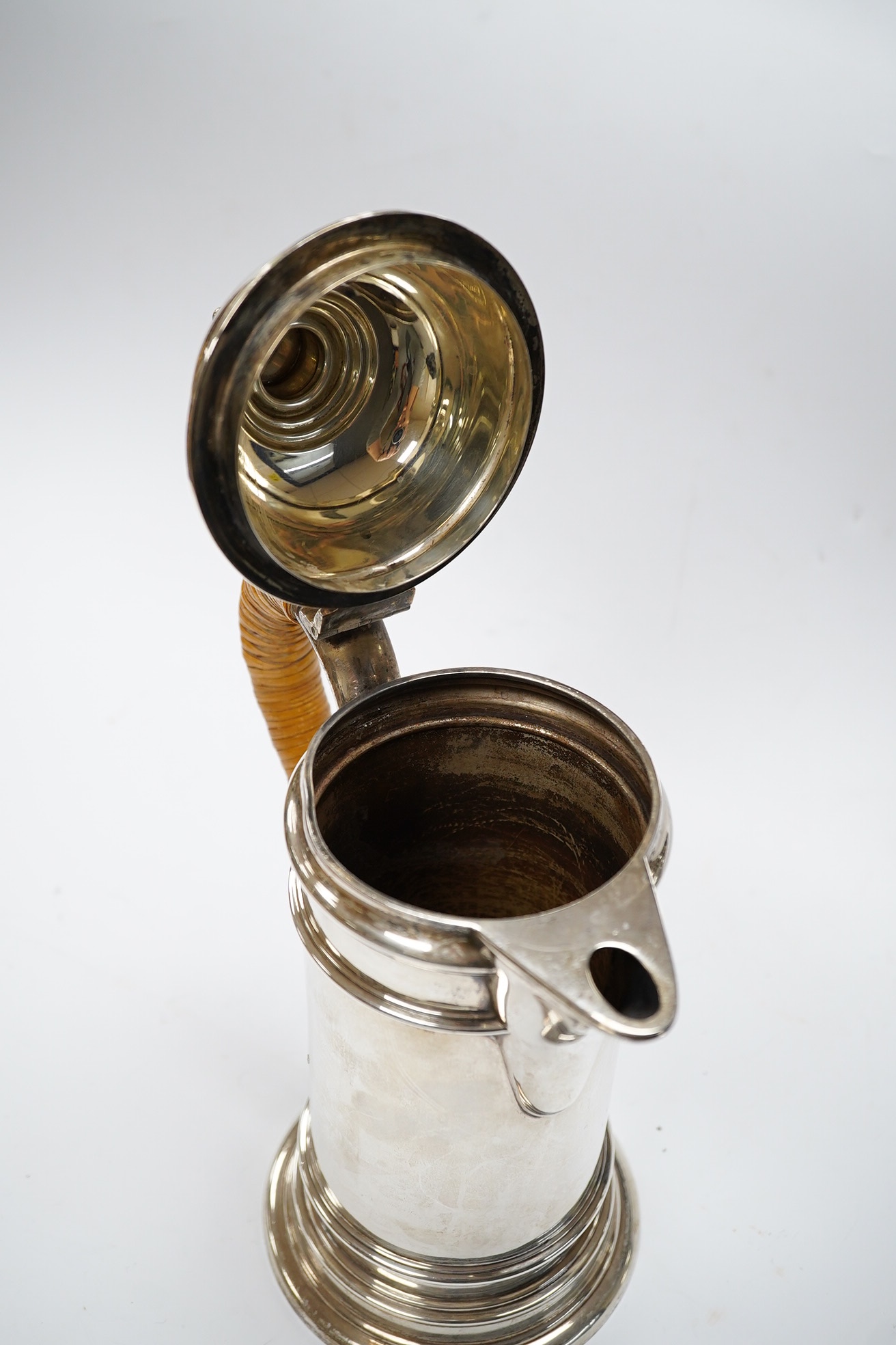 A George V silver cylindrical coffee pot, with a wicker handle, Birmingham, 1917 by Elkington & Co, 25.6cm, gross weight 23.1oz. Condition - fair